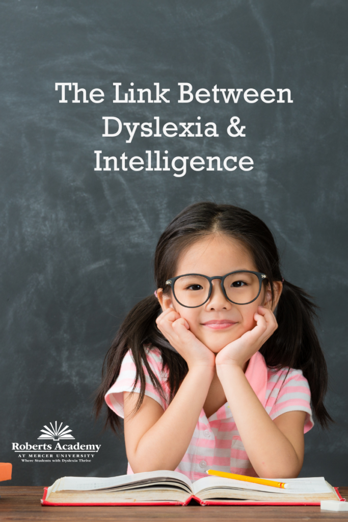 Image of a female elementary-aged student sitting at a desk with an open book. Text on the image reads: "The Link Between Dyslexia and Intelligence" 