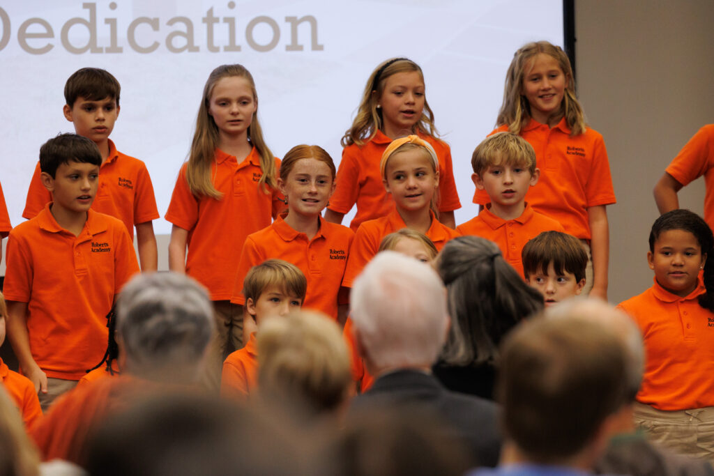 Students perform a song during the dedication of Roberts Academy at Mercer University.