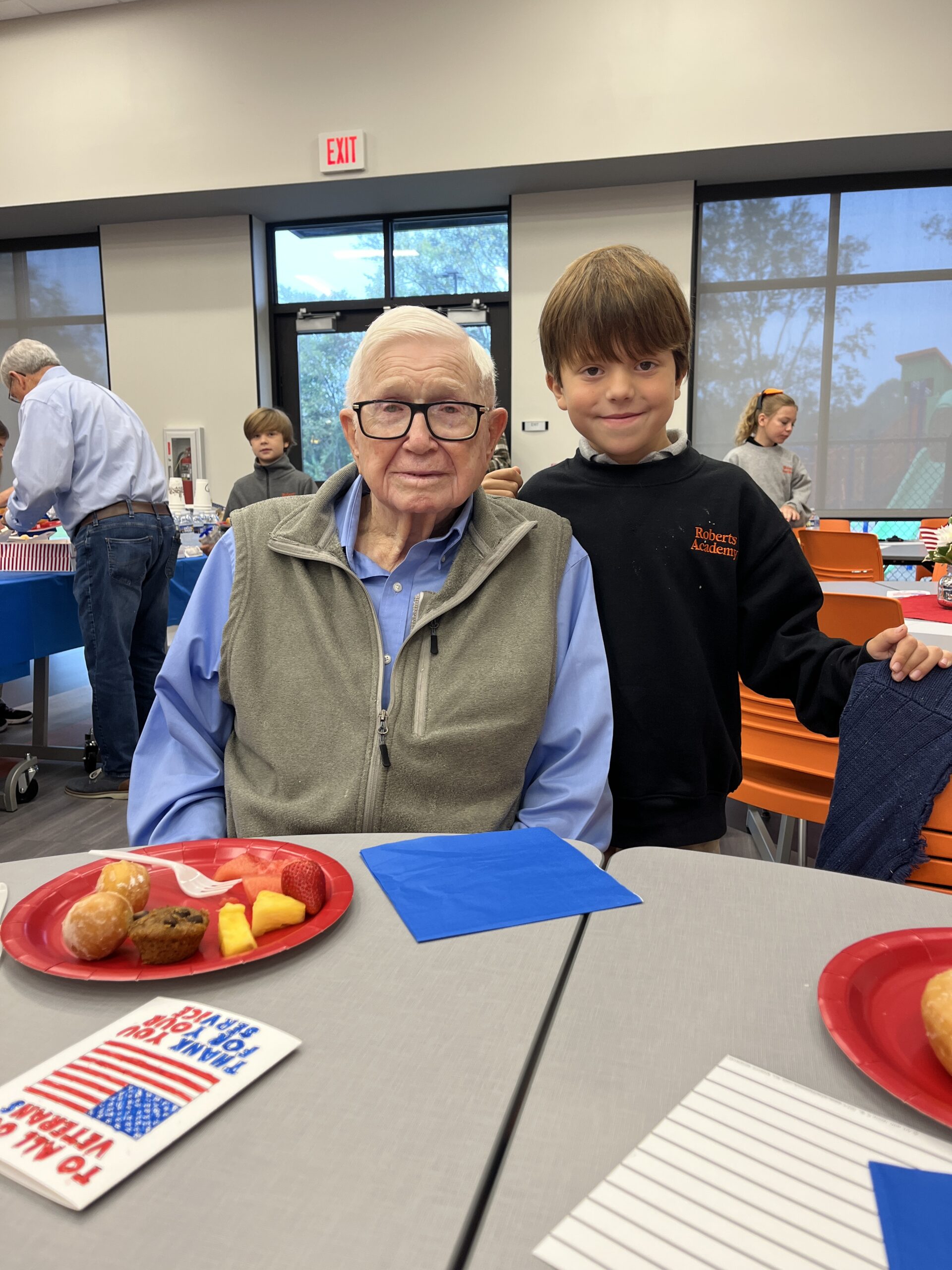 A Roberts Academy at Mercer University student poses with his Veteran Grandfather