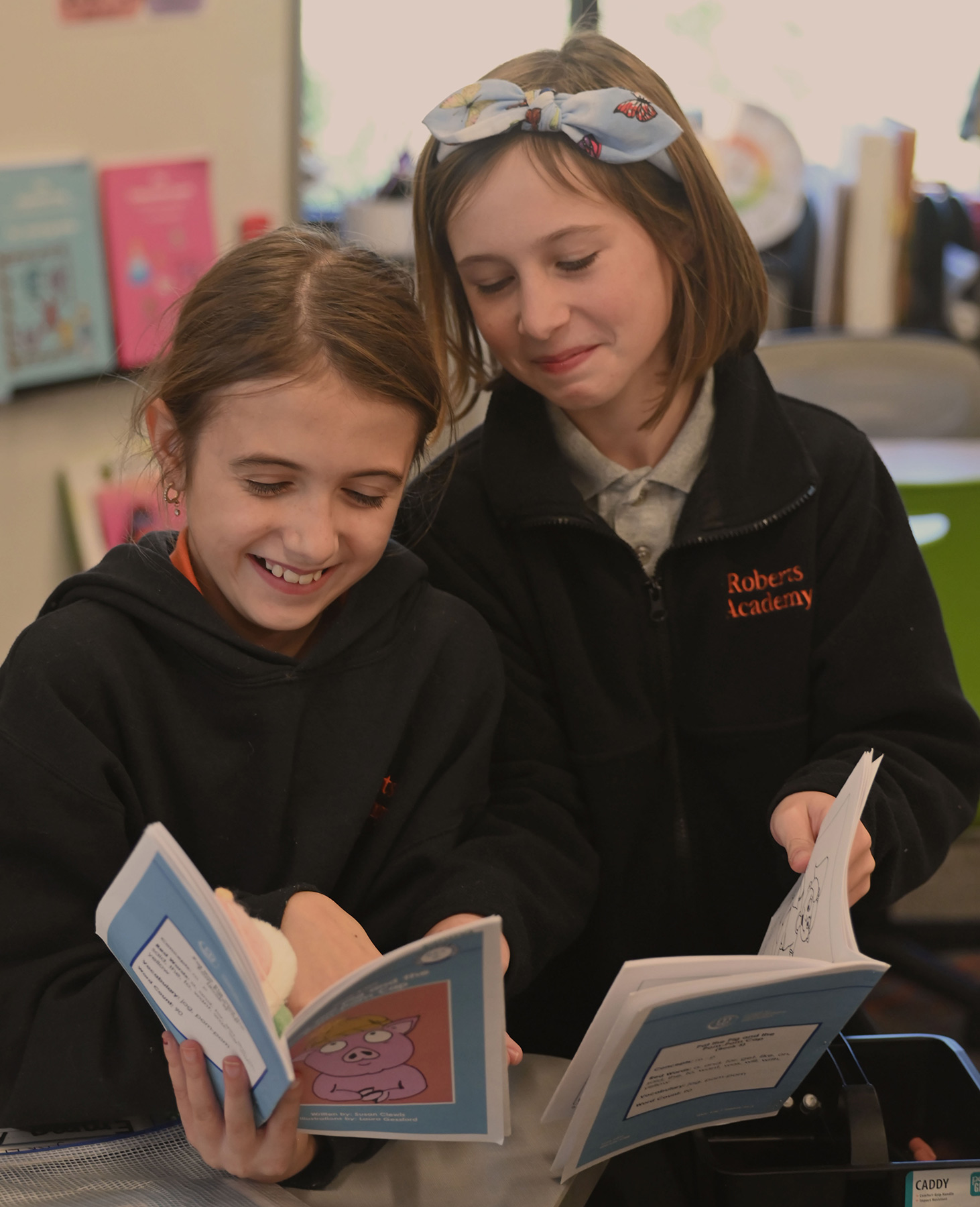 two students reading a book together at Roberts Academy at Mercer University