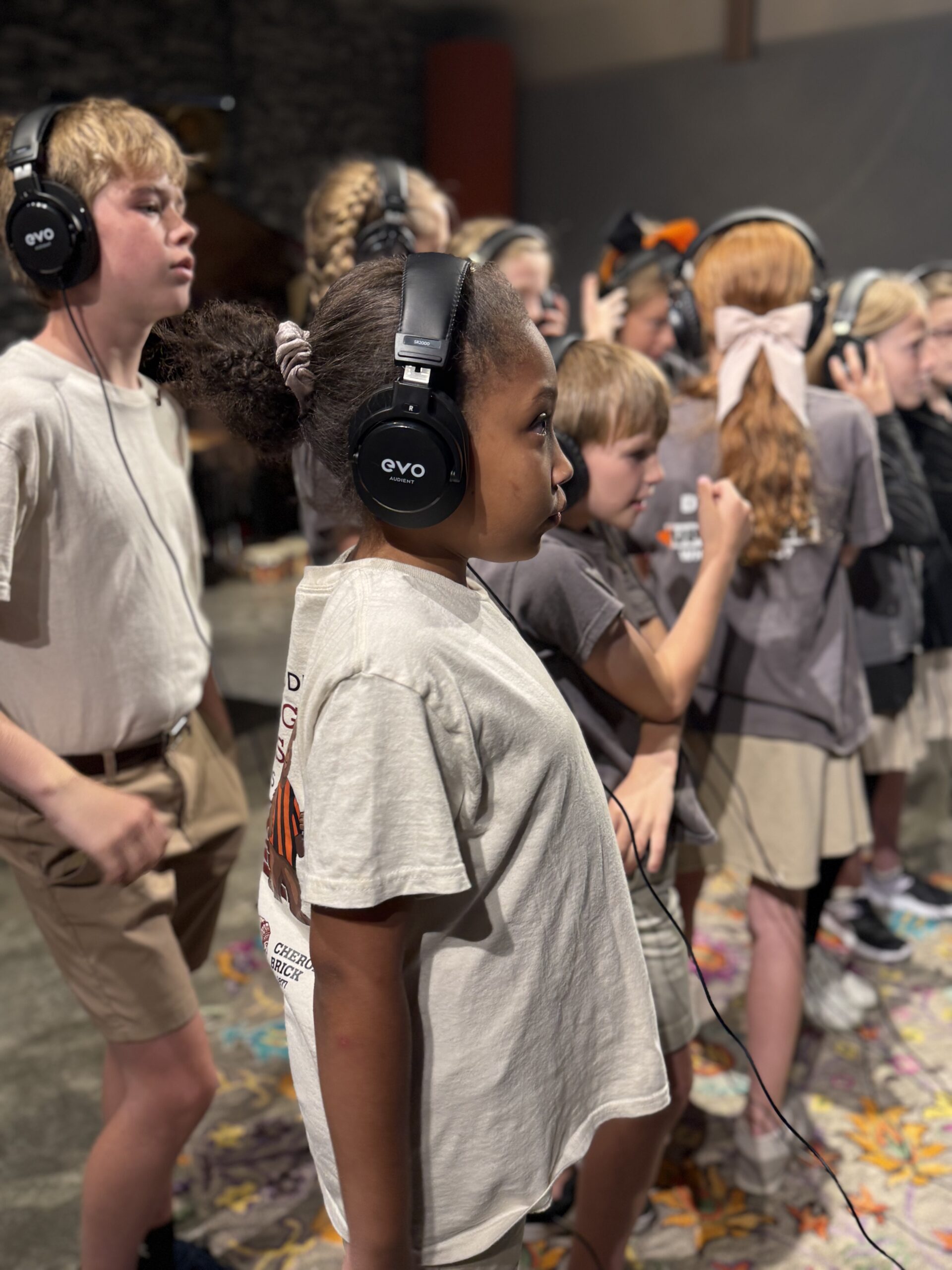"Elementary students from The Roberts Academy wearing headphones while recording 'We Are Heroes' music video in collaboration with the Otis Redding Center for the Arts."