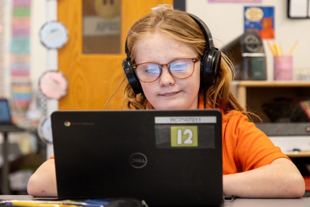 Rebekah works on a computer in her third grade classroom at Roberts at Mercer University